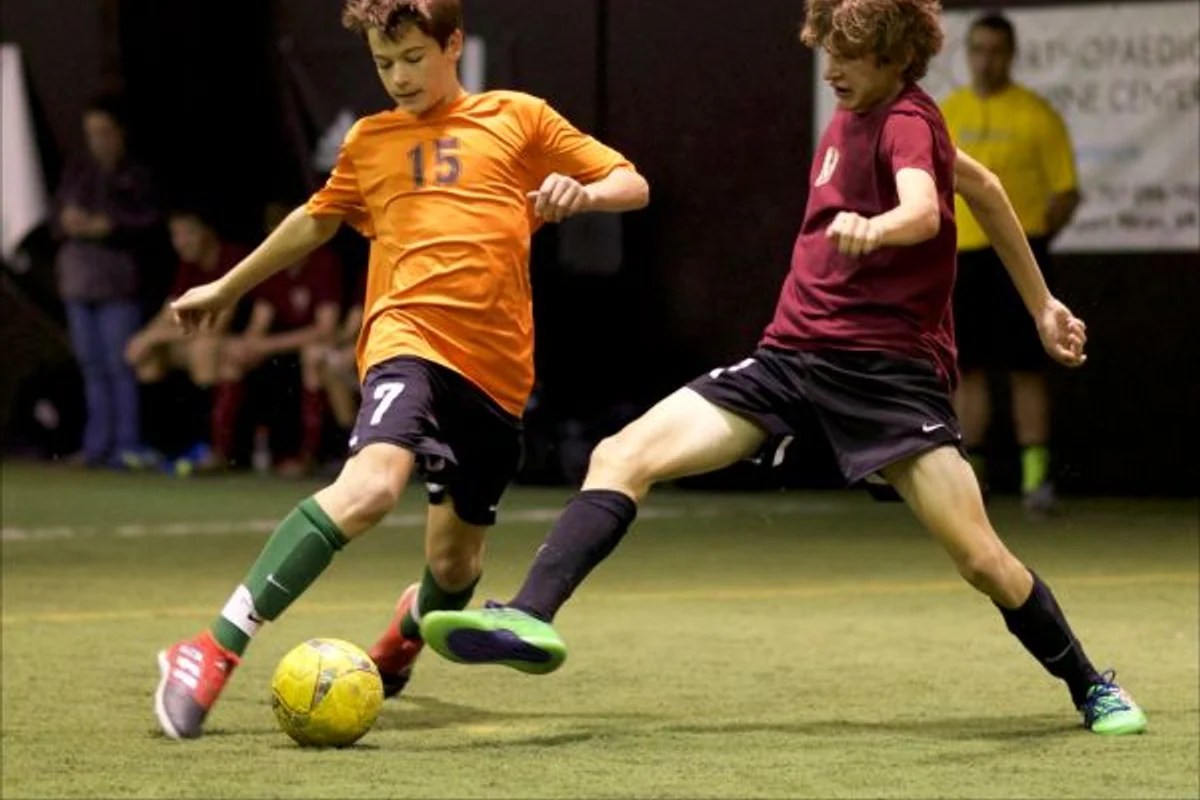 Young players competing in an indoor futsal game