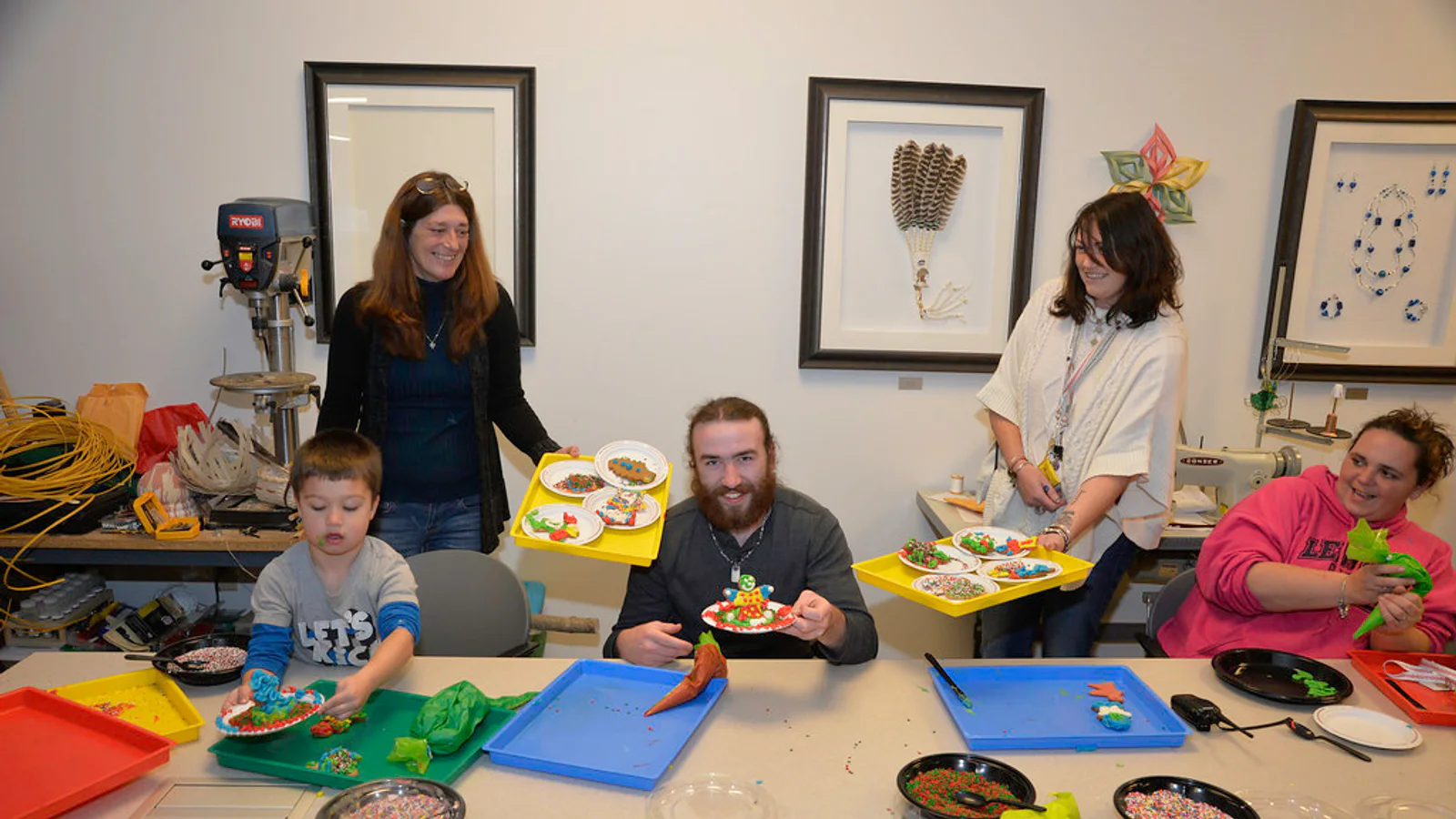 Adults and volunteers taking part in a hands-on community craft activity