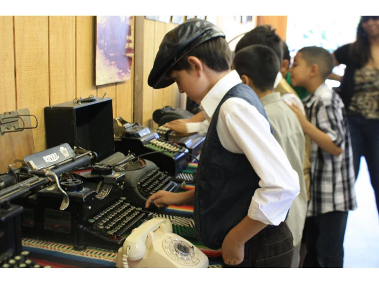 Students exploring antique typewriters during an East Contra Costa Historical Society local history program