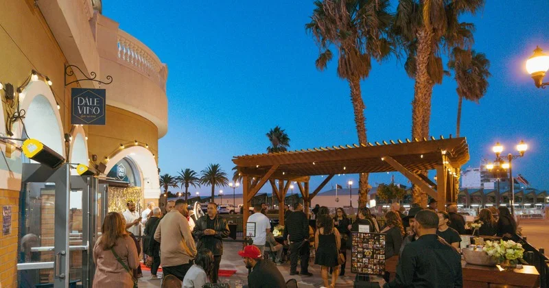 Dále Vino patio and storefront during an evening gathering at the Pittsburg Marina