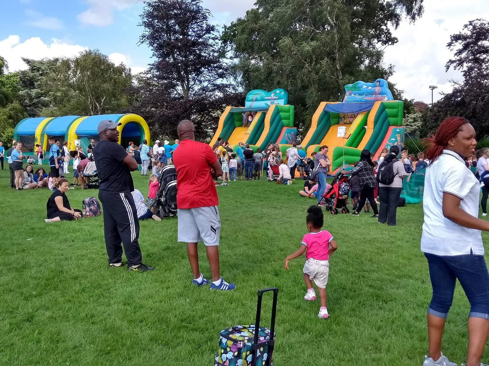 Families gathering at an outdoor park festival